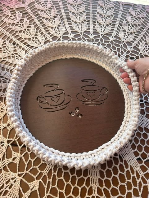 Chocolate cake with white piped border featuring two hand-drawn coffee cup illustrations on top
